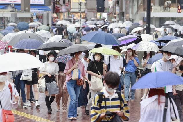 Resurging COVID-19 cases in Tokyo People wearing face masks walk in the rain in Tokyo s Shibuya district on July 14, 2022, as the Tokyo metropolitan government reports 16,662 COVID-19 cases the same day, doubling from a week earlier, amid a nationwide surge driven by the highly transmissible BA.5 subvariant of the Omicron variant.  A14AA0001314285P