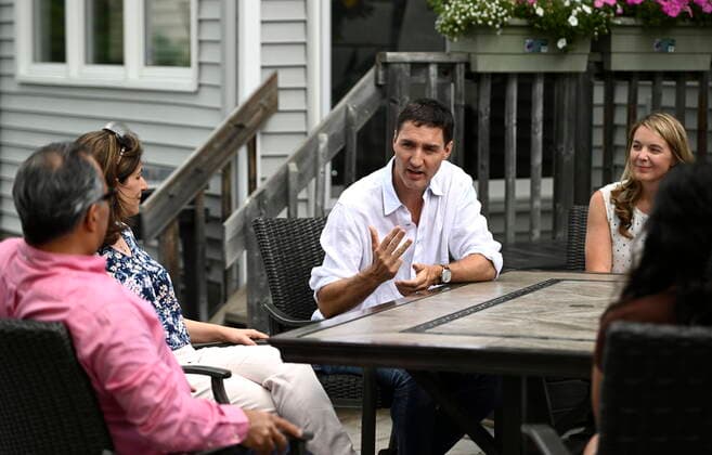 July 15, 2022, Ottawa, ON, CAN: Prime Minister Justin Trudeau and Liberal MP Jenna Sudds speak with Reza Matin, left, and Shirin Mohseni, second from left, about the Climate Action Incentive Payment at their backyard in Ottawa, on Friday, July 15, 2022. Ottawa CAN  - ZUMAc35_ 20220715_zaf_c35_045 Copyright: xJustinxTangx