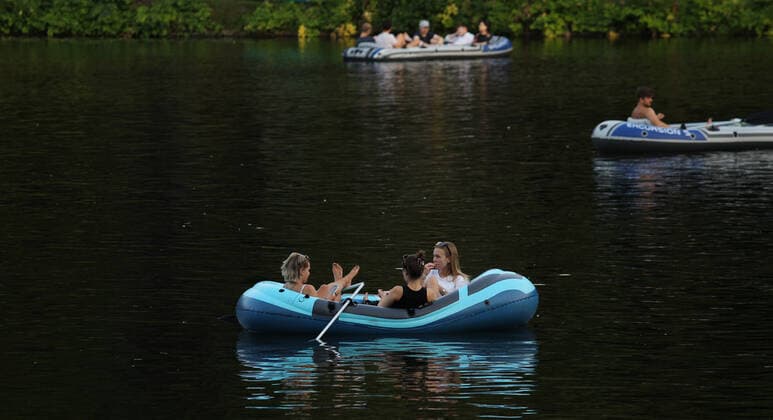 Drei Frauen sitzen in der Abenddämmerung auf einem Alsterkanal in einem Paddelboot . Am Dienstagabend herrschten in Hamburg bis in die späten Abendstunden noch Temperaturen bis an die 30 Grad. Hohenfelde Hamburg *** Three women sit in a paddle boat in the dusk on an Alster canal On Tuesday evening, temperatures in Hamburg were still up to 30 degrees Hohenfelde Hamburg until late in the evening hours.