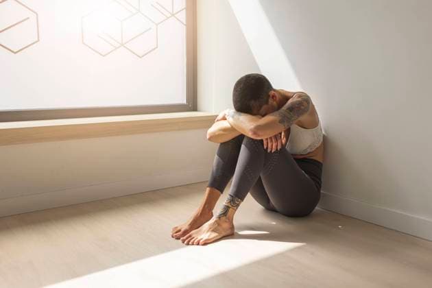 Sad woman sitting on floor by window model released, Symbolfoto property released, MTBF01237