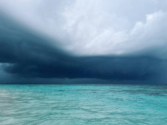 Creative Highlights World View on a clean ocean water with thunder clouds on horizon Copyright: xArtemxVarnitsinxArtemxVarnitsinx