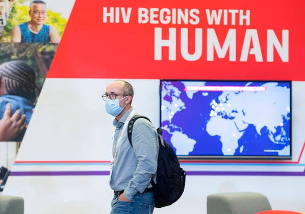 July 31, 2022, Montreal, PQ, Canada: A man walks by a sign during the AIDS 2022 conference in Montreal, Sunday, July 31, 2022. Montreal Canada  - ZUMAc35_ 20220731_zaf_c35_011 Copyright: xGrahamxHughesx