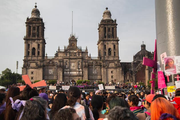 Protesters gathering in Zocalo, Central square during a Feminist March with over 80,000 participants in Mexico city. In Mexico at least 10 women are killed everyday and there is a big gender inequality. At this march women mainly were dressed with purple, green and black. Purple symbolizes the rejection to violence against women, green symbolizes the right of women to decide about her own body and life, and black for mourning. Mexico. AlejandroxParis xMajorityxWorld 3 8 2020 925_02_MWC046128