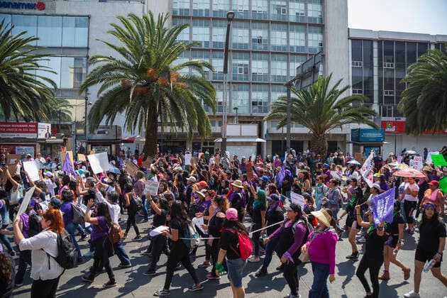 A group of women during a Feminist March with over 80,000 participants in Mexico city. In Mexico at least 10 women are killed everyday and there is a big gender inequality. At this march women mainly were dressed with purple, green and black. Purple symbolizes the rejection to violence against women, green symbolizes the right of women to decide about her own body and life, and black for mourning. Mexico. AlejandroxParis xMajorityxWorld 3 8 2020 925_02_MWC046131