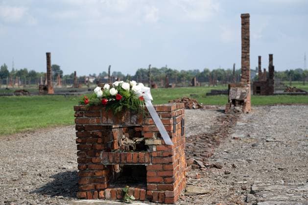 August 2, 2022, Brzezinka, Poland: Barracks rubble with the flowers seen at the former camp Auschwitz II Birkenau. Roma and Sinti Genocide Remembrance Day. 78 years ago, on the night of 2 to 3 August 1944, the Germans liquidated the camp for Gypsies (Zigeunerfamilienlager) in KL Auschwitz II Birkenau. The anniversary was organised at the former camp Auschwitz II-Birkenau. Brzezinka Poland - ZUMAs197 20220802_zaa_s197_025 Copyright: xWojciechxGrabowskix
