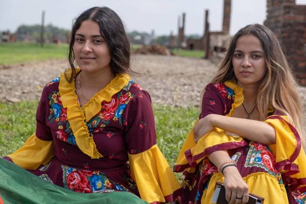 August 2, 2022, Brzezinka, Poland: Gypsy girls seen sitting on the grass at the former camp Auschwitz II Birkenau. Roma and Sinti Genocide Remembrance Day. 78 years ago, on the night of 2 to 3 August 1944, the Germans liquidated the camp for Gypsies (Zigeunerfamilienlager) in KL Auschwitz II Birkenau. The anniversary was organised at the former camp Auschwitz II-Birkenau. Brzezinka Poland - ZUMAs197 20220802_zaa_s197_033 Copyright: xWojciechxGrabowskix