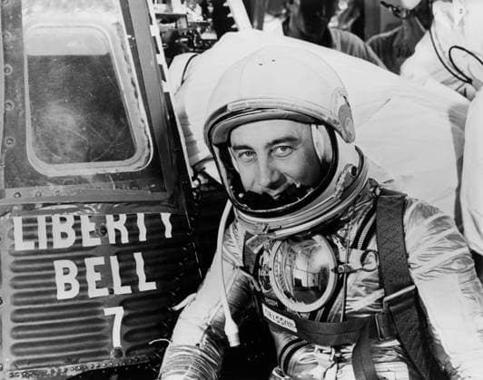 S61-03698 (1961) --- Astronaut Virgil I. (Gus) Grissom, suited up and ready to climb into Liberty Bell 7 spacecraft, sits in front of his capsule for a picture. Behind him technicians work inside the capsule. The Mercury-Redstone 4 (MR-4) mission was scrubbed a few hours later due to unfavorable weather over the launch pad. Copyright: xpiemagsx piemagsspace-868 !ACHTUNG AUFNAHMEDATUM GESCHÄTZT!