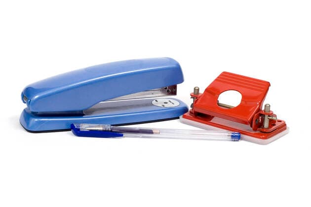 A stapler, hole punch and pen on a white background  Copyright: PaulxGibbings 30239611
