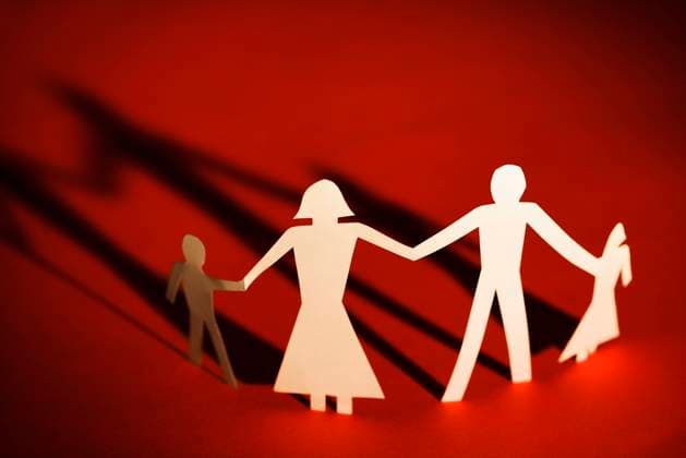 Creative Highlights Symbolbilder Paper cutout family of four standing holding hands.  Copyright: RonxChapplexStock 30303257