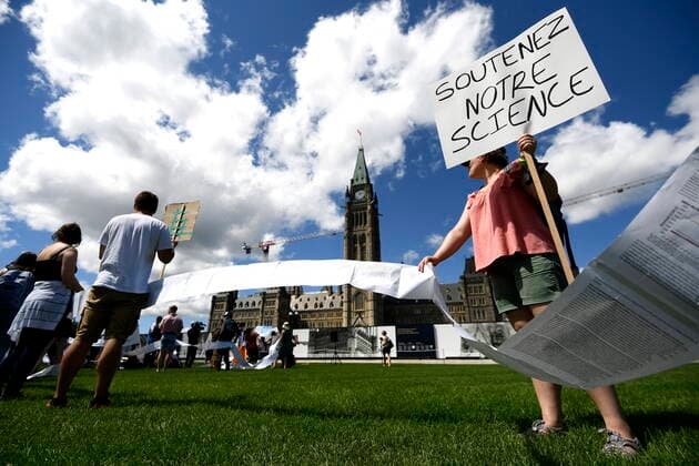 August 11, 2022, Ottawa, ON, CAN: Scientists and researchers hold a petition with over 7,100 signatures calling on the federal government to increase funding for graduate and post-doctoral scholars, during the öÄuSupport Our ScienceöÄÃ¹ rally on Parliament Hill in Ottawa, on Thursday, Aug. 11, 2022. Ottawa CAN  - ZUMAc35_ 20220811_zaf_c35_030 Copyright: xJustinxTangx