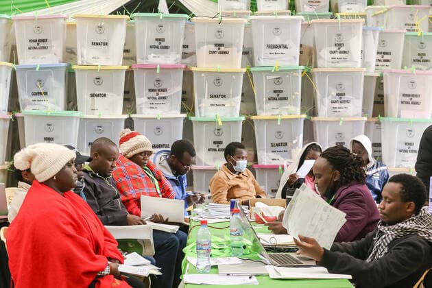 August 11, 2022, Nairobi, Kenya: The Independent Electoral and Boundaries Commission (IEBC) presiding officers (L) hand over election results from their polling stations to the returning officer (R) at Starehe Constituency tallying center in Nairobi. Tallying of results continue from Kenya™s general elections which was held on 9th August 2022. Nairobi Kenya - ZUMAs197 20220811_zab_s197_045 Copyright: xBonifacexMuthonix