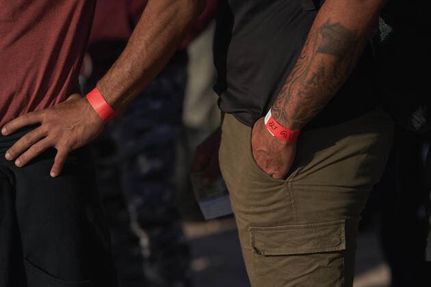 August 11, 2022, Normandy, Texas, US: Migrants, part of a group of over 200, wear their Mexican cartel wristbands as they are processed by U.S. Border Patrol after illegally crossing the Rio Grande River from Mexico into Normandy, Texas on Thursday August 11, 2022. Normandy US - ZUMAd211 20220811_zap_d211_002 Copyright: xAllisonxDinnerx