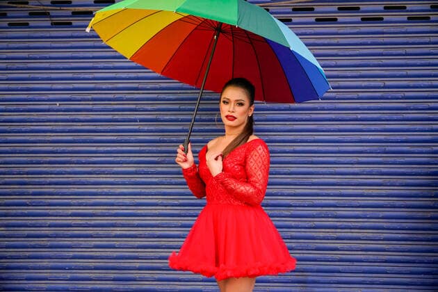 August 12, 2022, Kathmandu, Nepal: A Nepalese reveler poses for a photo while holding a rainbow umbrella during the pride parade of LGBTIQA (lesbian, gay, bisexual, queer, intersexual, transgender, asexual) at Thamel in Kathmandu. Hundreds gathered and attended the parade to display their presence on behalf of equality in society. Kathmandu Nepal - ZUMAs197 20220812_zaa_s197_040 Copyright: xSkandaxGautamx