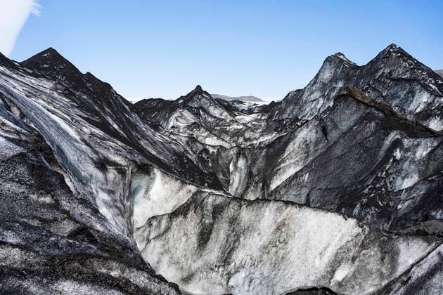 Creative Highlights World Picturesque scenery of rough glacier covered with volcanic ash against cloudless blue sky in Iceland JavierBallester_Iceland_12.jpg Copyright: xJavierxBallesterx Model Released