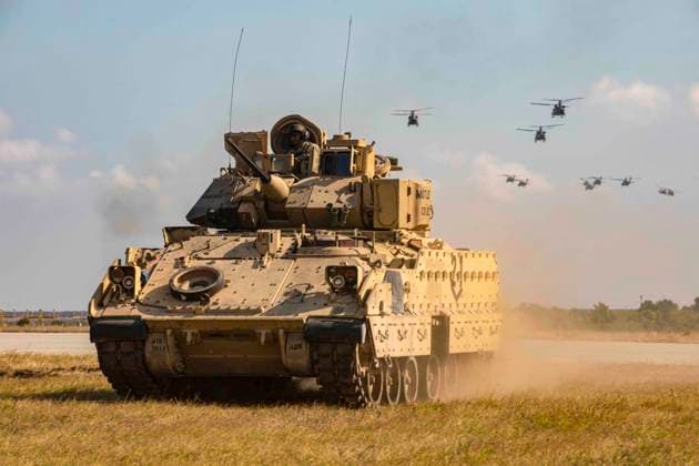 July 30, 2022 - Mihail Kogalniceanu, Romania - A Bradley Fighting Vehicle assigned to the 1st Battalion, 8th Infantry Regiment FIGHTING EAGLES, 3rd Armored Brigade Combat Team, 4th Infantry Division moves into position as UH-60 Blackhawks assigned to the 3rd Battalion, 227th Aviation Regiment, 1st Air Cavalry Brigade, 1st Air Cavalry Division, conduct a fly over during an Air Assault demonstration on July 30, 2022, at Mihail Kogalniceanu, Romania. 101st units will support V Corps mission to reinforce NATOs eastern flank and engage in multinational exercises with partners across the European continent to reassure our Nations allies. Mihail Kogalniceanu Romania - ZUMAz03_ 20220730_stw_z03_500 Copyright: xU.S.xArmyx