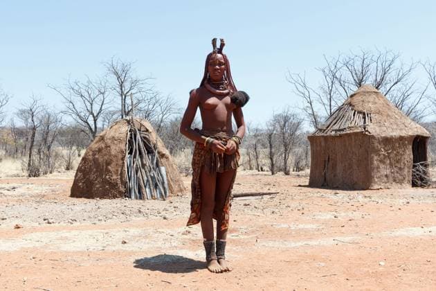 IMAGO Cultures of the world, Himba Volk in Namibia NAMIBIA, KAMANJAB, OCTOBER 10: Himba tribe woman with ornaments on the neck, in the village of Himba people near Kamanjab in northern Namibia, October 10, 2014, Namibia , 18179132.jpg, himba, northern, woman, culture, african, person, face, skin, tradition, tribal, native, authentic, beautiful, expression, necklace, hut, portrait, cultural, original, cute, head, bracelet, braid, smiling, front, nude, living, indigenous, africa, clay, ethnic, female, girl, hair, local, may, mud, namibia, natural, nature, near, outdoor, people, south, style, traditional, tribe, village, women, young,