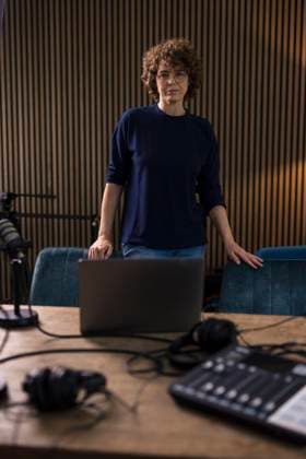 Radio DJ standing by desk in recording studio model released, Symbolfoto property released, JOSEF11151
