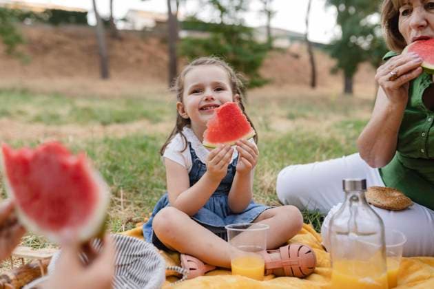 Cute girl holding watermelon sitting by grandmother model released, Symbolfoto, JCCMF06839