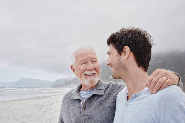 Proud father standing on the beach with his adult son model released, Symbolfoto, RORF02981