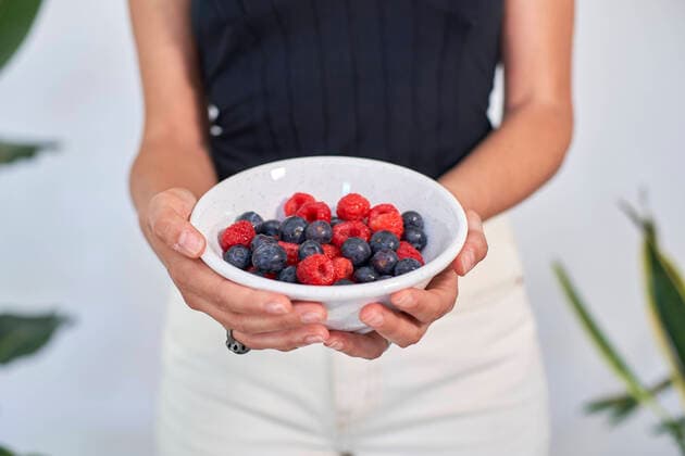 Hands of woman holding bowl of fresh berries model released, Symbolfoto property released, VEGF05748