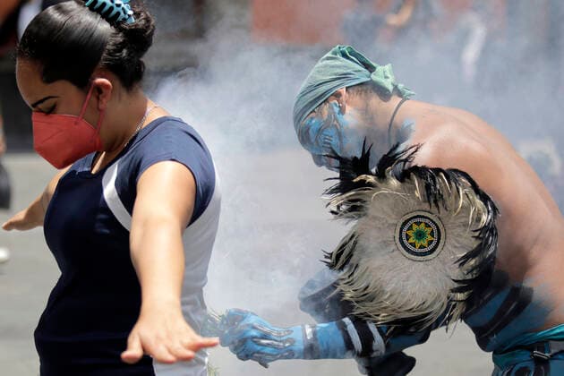 August 23, 2022, Mexico City, DF, Mexico: A woman gets purified by one of the Pre-Hispanic dancers, disguised as Aztec warrior take part during a ritual the Main Temple ruins to make people aware of the importance of the rehabilitation of Lake Tlahuac-Xico, which consists of the sanitation and purification of water, environmental restoration through the establishment of irrigation systems on Tuesday. Mexico City Mexico - ZUMAe321 20220823_smp_e321_016 Copyright: xGerardoxVieyrax