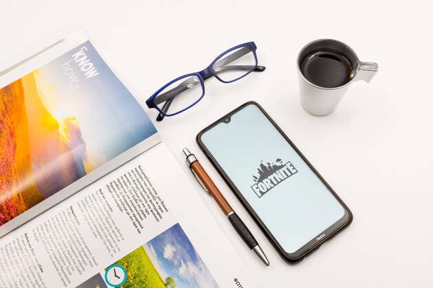 Logo Photo Illustration In this photo illustration a Fortnite logo seen displayed on a smartphone screen on a desk next to a cafe, a pen, glasses and a magazine in Athens, Greece on August 26, 2022. (Photo illustration by Nikolas Kokovlis NurPhoto illustration) Athens Greece  Copyright: xNikolasxKokovlisx originalFilename: kokovlis-notitle220826_npP0a.jpg
