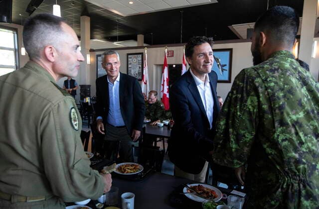 August 26, 2022, COLD LAKE, AB, CANADA: Prime Minister Justin Trudeau, right, and NATO Secretary General Jens Stoltenberg meet with military during a luncheon with members of the Canadian Armed Forces at 4 Wing Cold Lake air base in Cold Lake Alta, on Friday August 26, 2022. COLD LAKE CANADA  - ZUMAc35_ 20220826_zaf_c35_036 Copyright: xJasonxFransonx