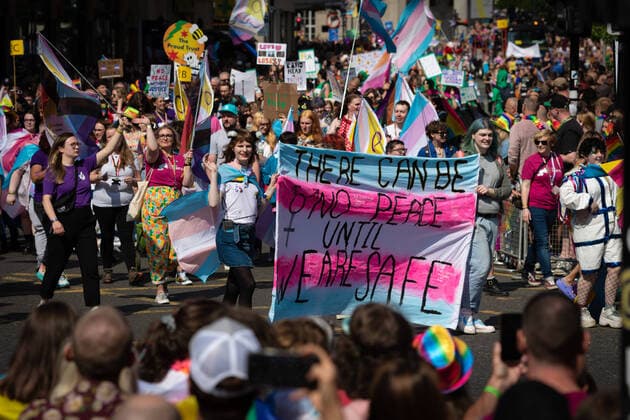 August 27, 2022, Manchester, United Kingdom: The LGBTQIA+ community hold a banner and placards during the Pride Parade. This year sees the parade come back in full capacity for the first time since 2019. Manchester United Kingdom - ZUMAs197 20220827_zab_s197_001 Copyright: xAndyxBartonx