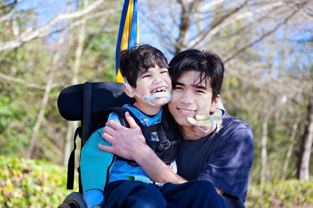 Little disabled boy in wheelchair hugging older brother outdoors, smiling together. Child has cerebral palsy., model released, , 4374569.jpg, biracial, asian, thai, mixed race, multiethnic, ethnicity, minority, child, kid, small, boys, male, handsome, cute, happy, smiling, fun, outdoors, park, hugging, sitting, enjoying, childhood, wheelchair, disabled, special needs, mobility, immobility, handicap, impaired, disability, cerebral palsy, palsy, six years old, little, healthy lifestyle, medical, equipment, brother, family, sibling, caretaker, together, relationship, love, fun, teenage, teen, holding, sunny, joy,