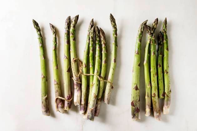 Bundle of green asparagus Bundle of raw organic green asparagus with thread over white marble background. Flat lay, space Copyright: xNatashaxBreenx NB080519-14