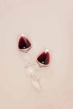 Flat-lay of red wine in glasseson pink background. Wine bar, winery, wine degustation concept. Minimalistic trendy photography Flat-lay of red wine in glasseson pink background. Wine bar, winery, wine degustation concept. Minimalistic trendy photography Copyright: xNataliaxKlenovax NK200622-36