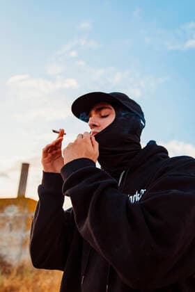 Creative Highlights Symbolbilder Guy with balaclava smoking a joint of marijuana outdoors Lleida, Catalonia, Spain CR_AICA220830-1032992-01 ,model released, Symbolfoto