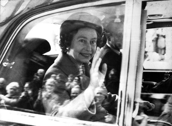 May 01, 1980 - Berne, Switzerland - QUEEN ELIZABETH II, waving, and her husband, PRINCE PHILIP, partial view right, started the first ever State visit to Switzerland by a reigning British Monarch when they arrived in Berne on Tuesday. The Queen waves to the crowd gathered to welcome her as she drives with Prince Philip from the airport through the streets of Berne. Berne Switzerland - ZUMAk09_ 19800501_baf_k09_004 Copyright: xKeystonexPressxAgencyx