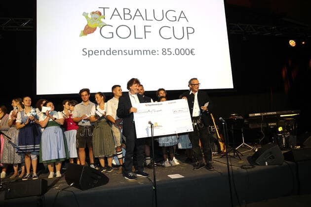 28. Tabaluga Golf Cup Michael Roll und seine Frau Claudia überreichen den Chef der Tabaluga Stiftung Dr. Jürgen Haerlin einen Spenden Scheck über 90.000 Euro, Tutzing Bayern Deutschland Golfplatz Tutzing