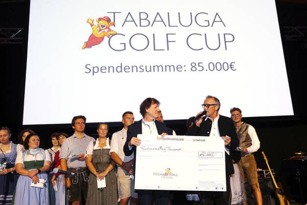 28. Tabaluga Golf Cup Michael Roll und seine Frau Claudia überreichen den Chef der Tabaluga Stiftung Dr. Jürgen Haerlin einen Spenden Scheck über 90.000 Euro, Tutzing Bayern Deutschland Golfplatz Tutzing
