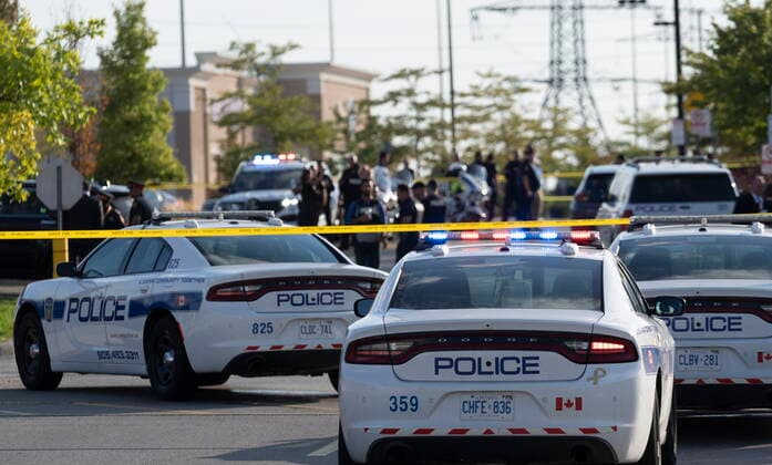 September 12, 2022, Mississauga, ON, CANADA: Police vehicles and officers are seen behind tape at a scene in Mississauga, Ont., Monday, Sept. 12, 2022. A Toronto police officer has been fatally shot and a suspect is in custody after two separate shootings left two dead and three injured in the Greater Toronto Area on Monday afternoon. Mississauga CANADA  - ZUMAc35_ 20220912_zaf_c35_111 Copyright: xArlynxMcadoreyx
