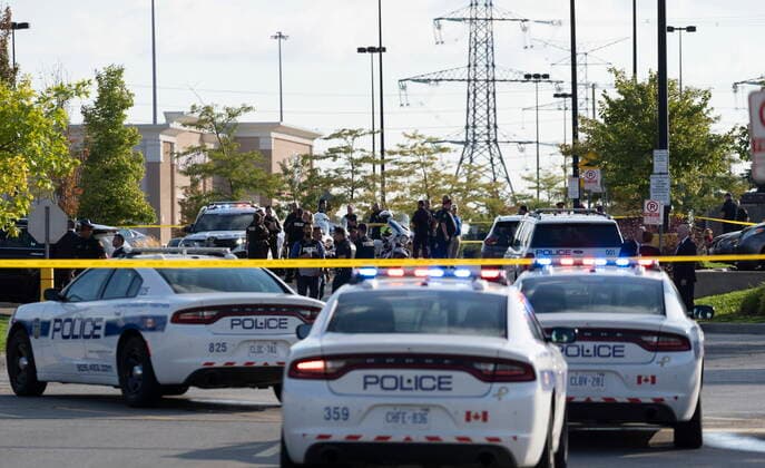 September 12, 2022, Mississauga, ON, CANADA: Police vehicles and officers are seen behind tape at a scene in Mississauga, Ont., Monday, Sept. 12, 2022. A Toronto police officer has been fatally shot and a suspect is in custody after two separate shootings left two dead and three injured in the Greater Toronto Area on Monday afternoon. Mississauga CANADA  - ZUMAc35_ 20220912_zaf_c35_112 Copyright: xArlynxMcadoreyx