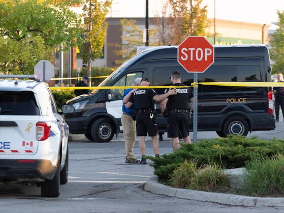 September 12, 2022, Mississauga, ON, CANADA: Police officers embrace at the scene of a shooting in Mississauga, Ont., Monday, Sept. 12, 2022. A Toronto police officer has been fatally shot and a suspect is in custody after two separate shootings left two dead and three injured in the Greater Toronto Area on Monday afternoon. Mississauga CANADA  - ZUMAc35_ 20220912_zaf_c35_173 Copyright: xArlynxMcadoreyx