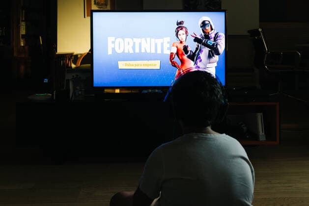 Teenager playing Fortnite video game with PlayStation on TV Madrid, Spain - May 29, 2019: Teenager playing Fortnite video game withn Playstation on TV. Fortnite is an online multiplayer video game developed by Epic Games Copyright: xZoonar.com @jjfarquitectosx zoonar_13928133 ,model released, Symbolfoto ,property released
