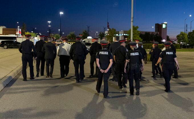 September 12, 2022, Mississauga, ON, CANADA: Police officers walk away after speaking to the media at the scene of a shooting in Mississauga, Ont., Monday, Sept. 12, 2022. Cst. Andrew Hong, of the Toronto Police Service, was fatally shot after two separate shootings left two dead and three injured in the Greater Toronto Area on Monday afternoon. Mississauga CANADA  - ZUMAc35_ 20220912_zaf_c35_190 Copyright: xArlynxMcadoreyx