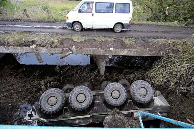 KHARKIV REGION, UKRAINE - SEPTEMBER 13, 2022 - A van moves along a bridge as a destroyed Russian military vehicle is seen by the side of the road leading to Balakliia which was liberated from Russian invaders by the Ukrainian army in the course of the counteroffensive in Kharkiv Region, northeastern Ukraine. Road to Balakliia liberated from Russian invaders  Copyright: xVyacheslavxMadiyevskyyx