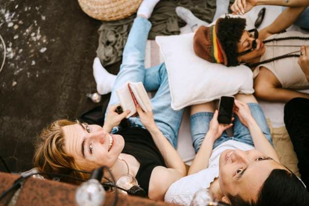 High angle view of male friends sitting by woman lying down Germany, Berlin, model released, property released Copyright: xMaskot,xMaskotxBildbyraxABx , MA95104 MA95104