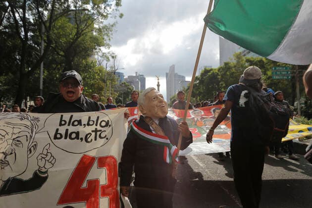 September 26, 2022, Mexico, Mexico: A protester disguises himself of Mexican President Andres Manuel Lopez Obrador seen during a demonstration to commemorate the 8th anniversary of the disappearance of the 43 Ayotzinapa students. On the night of September 26, 2014, 43 students from the Raoel Isidro Burgos Rural Normal School located in Iguala, Guerrero, were victims of forced disappearance by members of public security from the state of Guerrero and federal military security..The students had allegedly tried to hijack trucks to use for their protests. Mexico Mexico - ZUMAs197 20220926_zaa_s197_337 Copyright: xGuillermoxDiazx