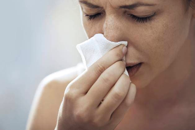 Ill woman blowing nose with tissue paper model released, Symbolfoto, AZF00431
