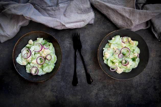Studio shot of two bowls of cucumber salad with yogurt, onions and feta cheese, LVF09230