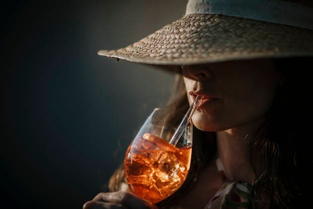 Woman wearing hat having drink with straw model released, Symbolfoto property released, MJRF00784
