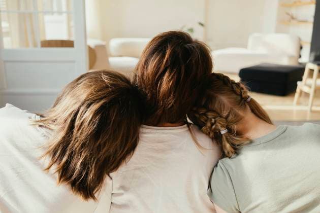 Siblings leaning heads on mother s shoulder in living room at home model released, Symbolfoto property released, SEAF01178