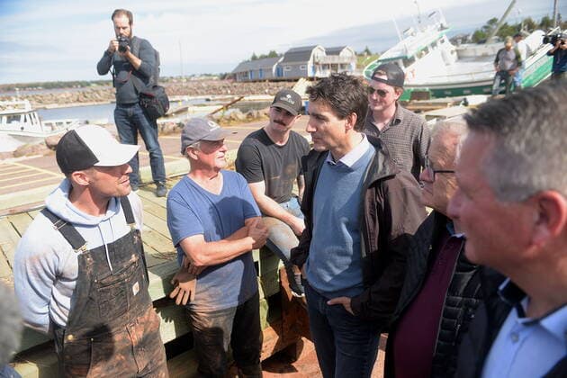 September 27, 2022, Stanley Bridge, PEI, Canada: Prime Minister Justin Trudeau speaks with Mitch Jollimore, left, lobster fisherman and business owner of StanleyöÄÃ s fish and chips and Basin View Seafood as he visits Stanley Bridge, P.E.I., to see the damage done by post-tropical storm Fiona, on Tuesday, Sept. 27, 2022. Second from right is Veterans Affairs Minister Lawrence MacAulay and at right, Liberal MP for Malpeque Heath MacDonald. Stanley Bridge Canada - ZUMAc35_ 20220927_zaf_c35_086 Copyright: xBrianxMcinnisx