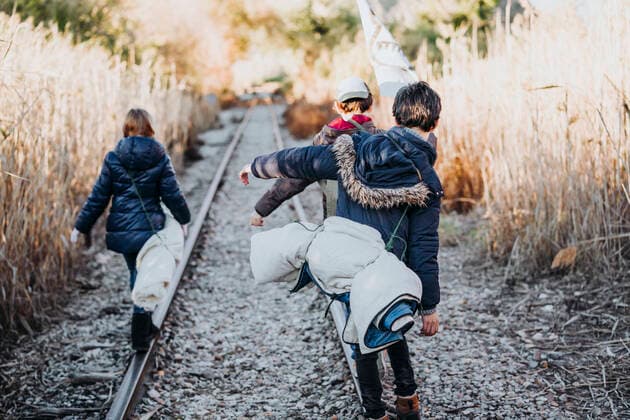 Back view of unrecognizable group of three children hiking in the woods walking in a train track, Model released JoseLuisCarrascosa_AdventureBoys_4 Copyright: xJosexLuisxCarrascosax MR