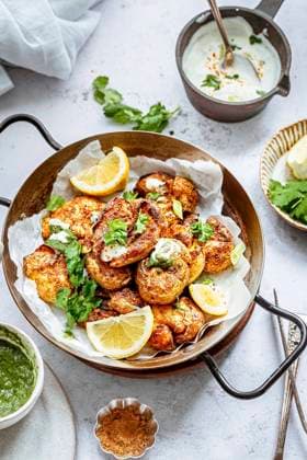 A serving platter with curried indian mashed potatoes, garnished with coriander leaves and lemon A serving platter with curried indian mashed potatoes, garnished with coriander leaves and lemon Copyright: xSandhyaxHariharanx SH210122-25
